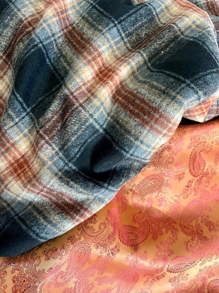 Brown and grey tartan and orange Paisley print material