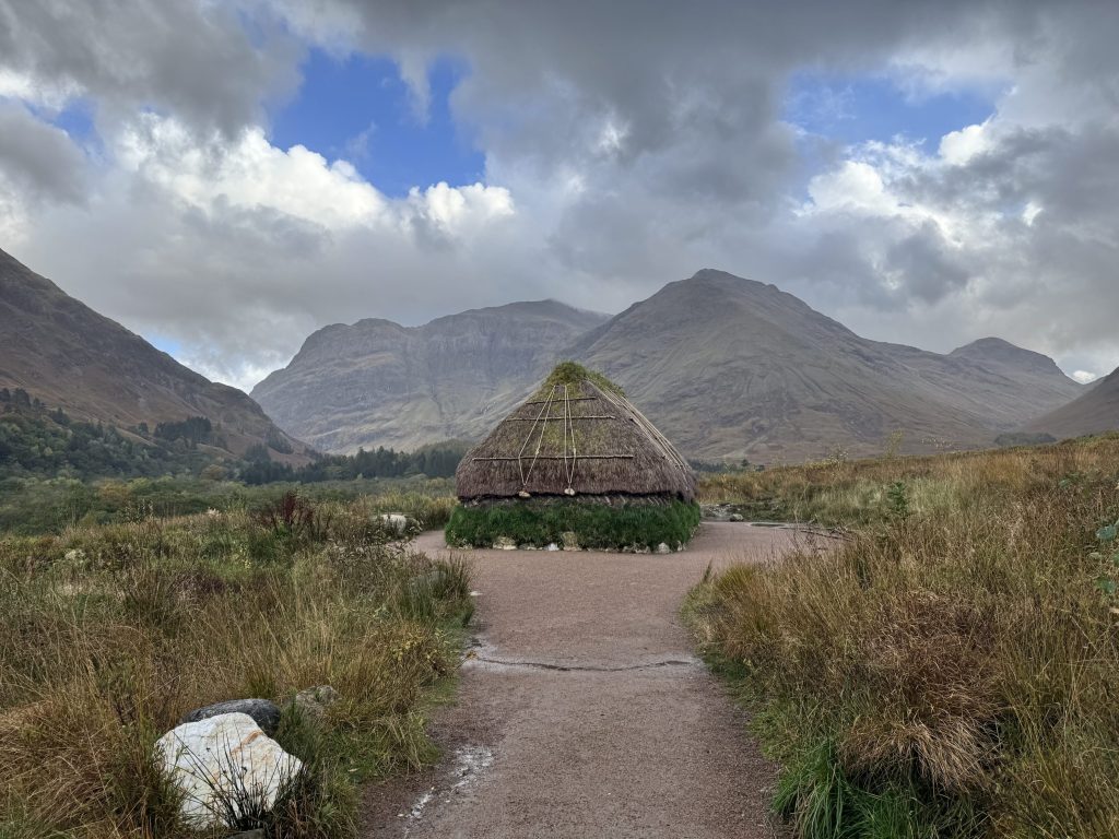 Turf and creel house at Glencoe surrounded by mountains