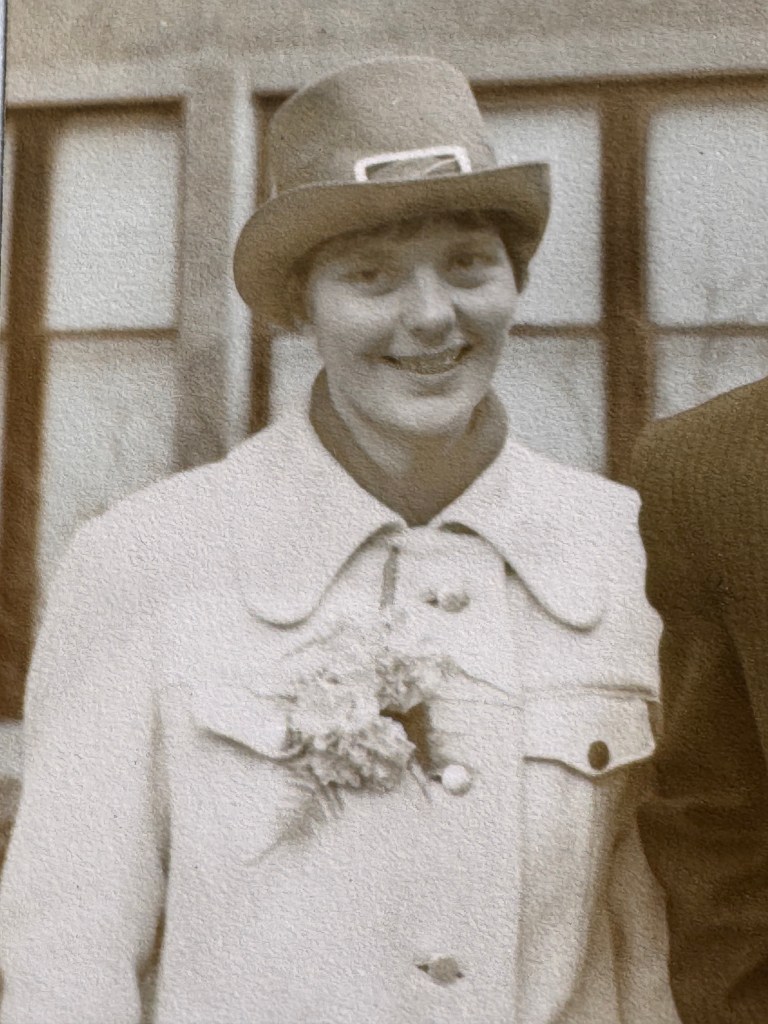 Black and white photograph of a woman wearing a hat and coat
